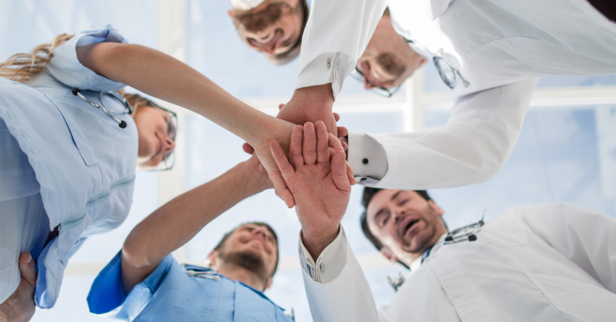 a group of healthcare workers in a team huddle
