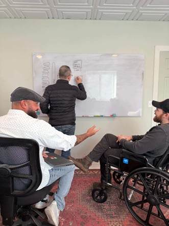 White board and a man in a wheelchair